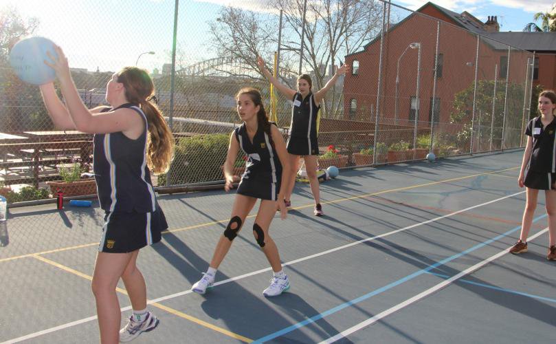 Girls Playing Netball on Court
