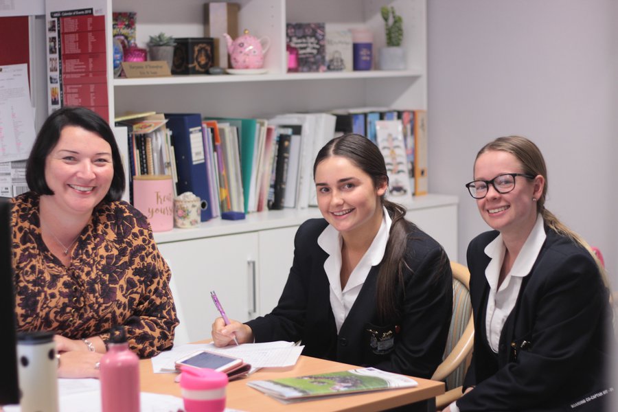Director of Boarding Sitting with Two Students