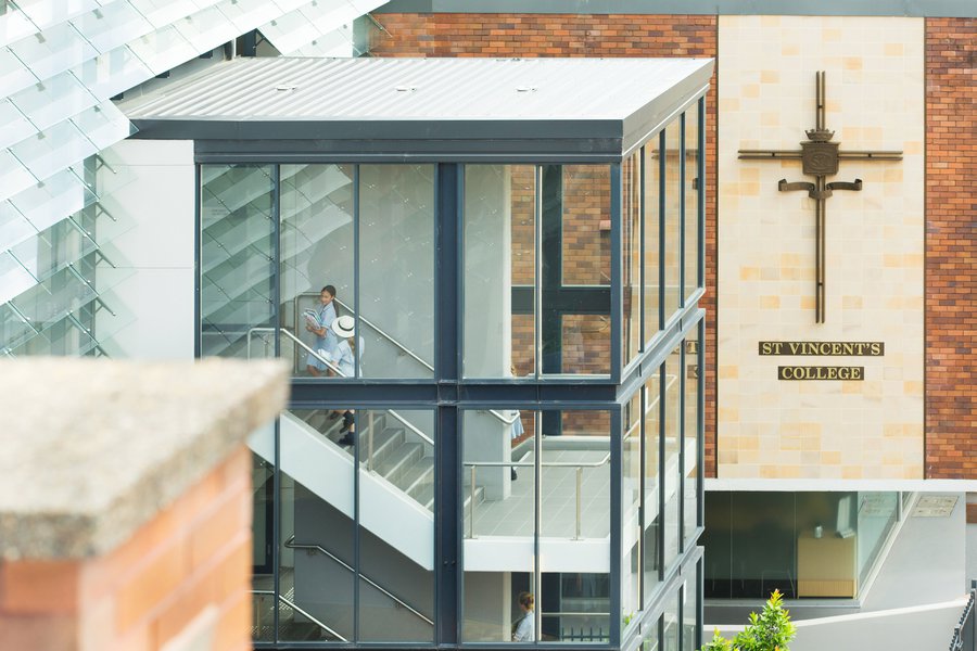 College External View of Students Walking Up the Stairs