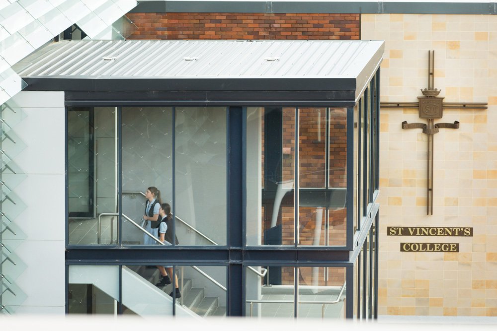 Exterior Shot of Students Walking Up the Stairs to Class